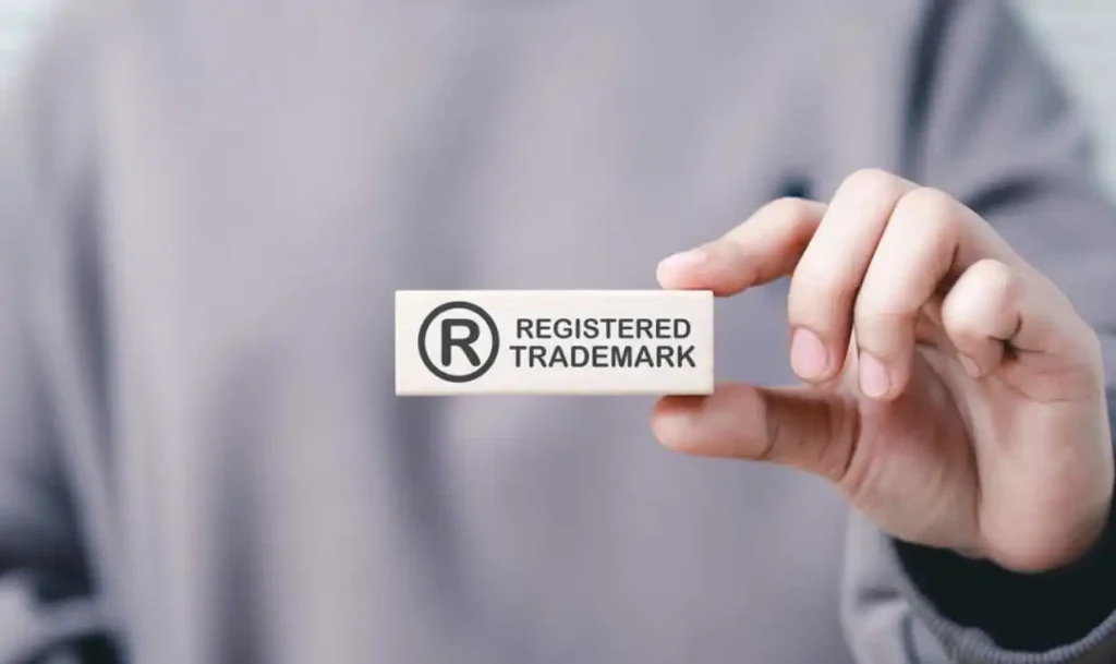 Hand holding registered trademark symbol stamp