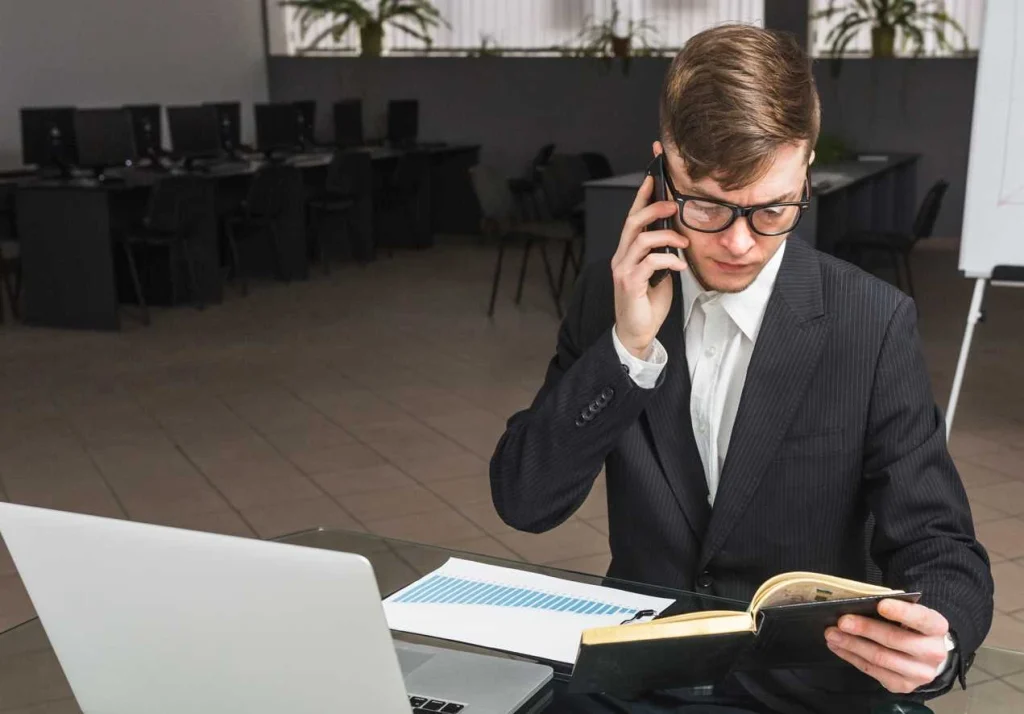 businessman reviewing trademark documents on laptop