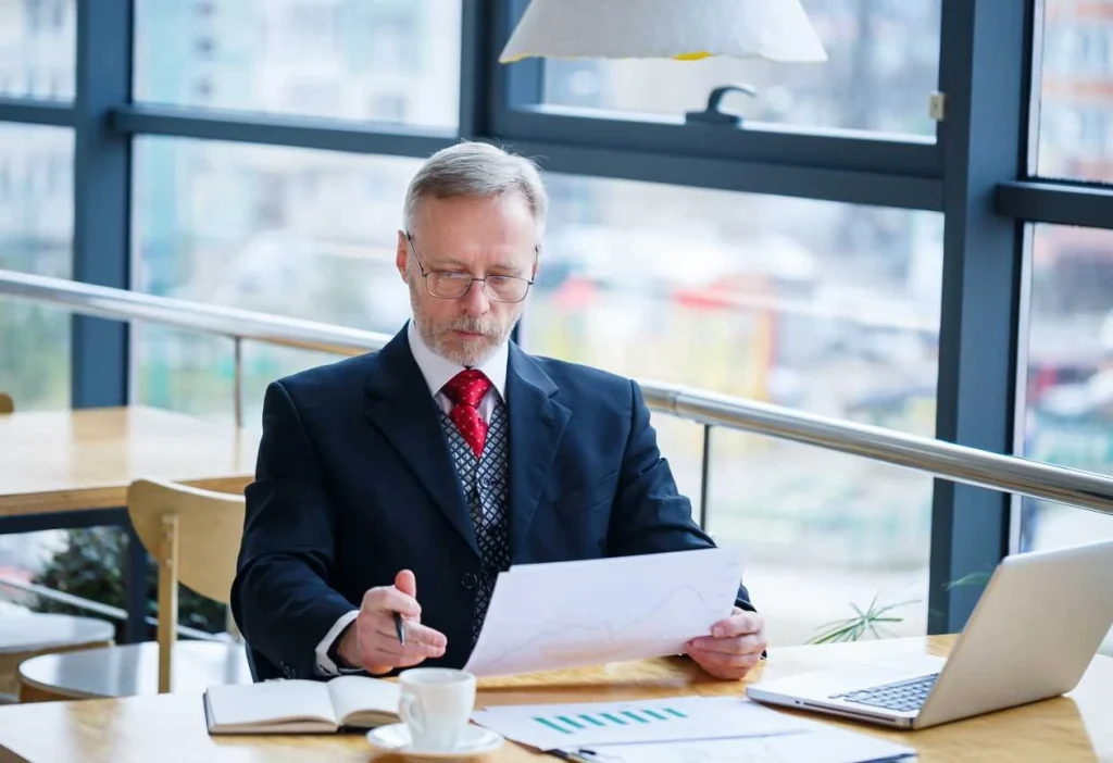 senior executive checking business reports at desk