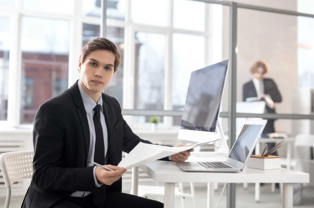 young professional analyzing paperwork in office