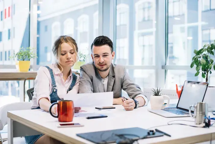 Team discussing documents in bright coworking office