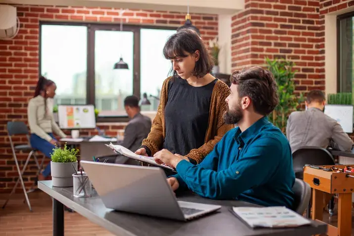 Creative coworkers collaborating in modern workspace