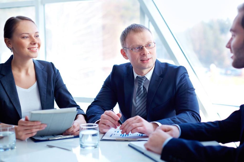 Business professionals in a meeting discussing intellectual property strategy.