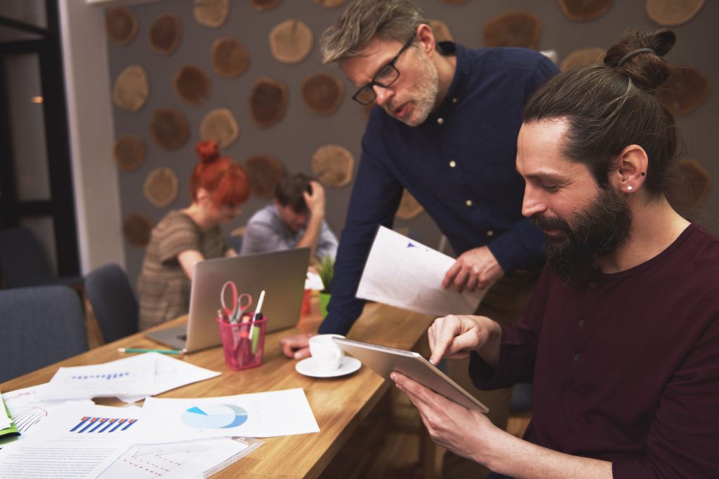 Startup founders reviewing trademark registration documents together
